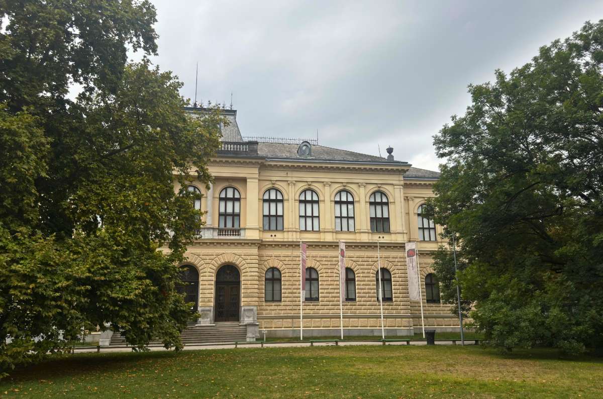 a photo of the National Museum of Slovenia building surrounded by trees, Ljubljana, Slovenia, photo by Next Level of Travel
