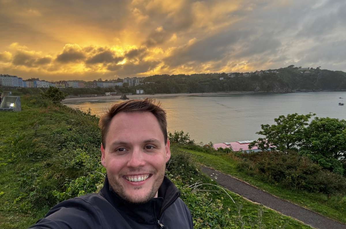 a photo of a tourist taking a selfie above Tenby North Beach at sunset, Tenby, Wales, photo by Next Level of Travel