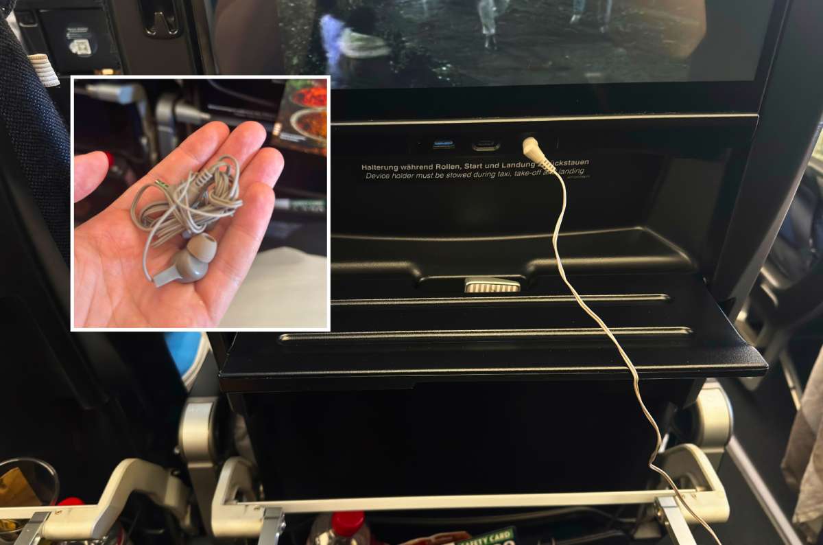 a photo of the Condor Premium Economy seatback with USB ports and a headphone jack, with an inset of the supplied in-ear headphones, photo by Next Level of Travel