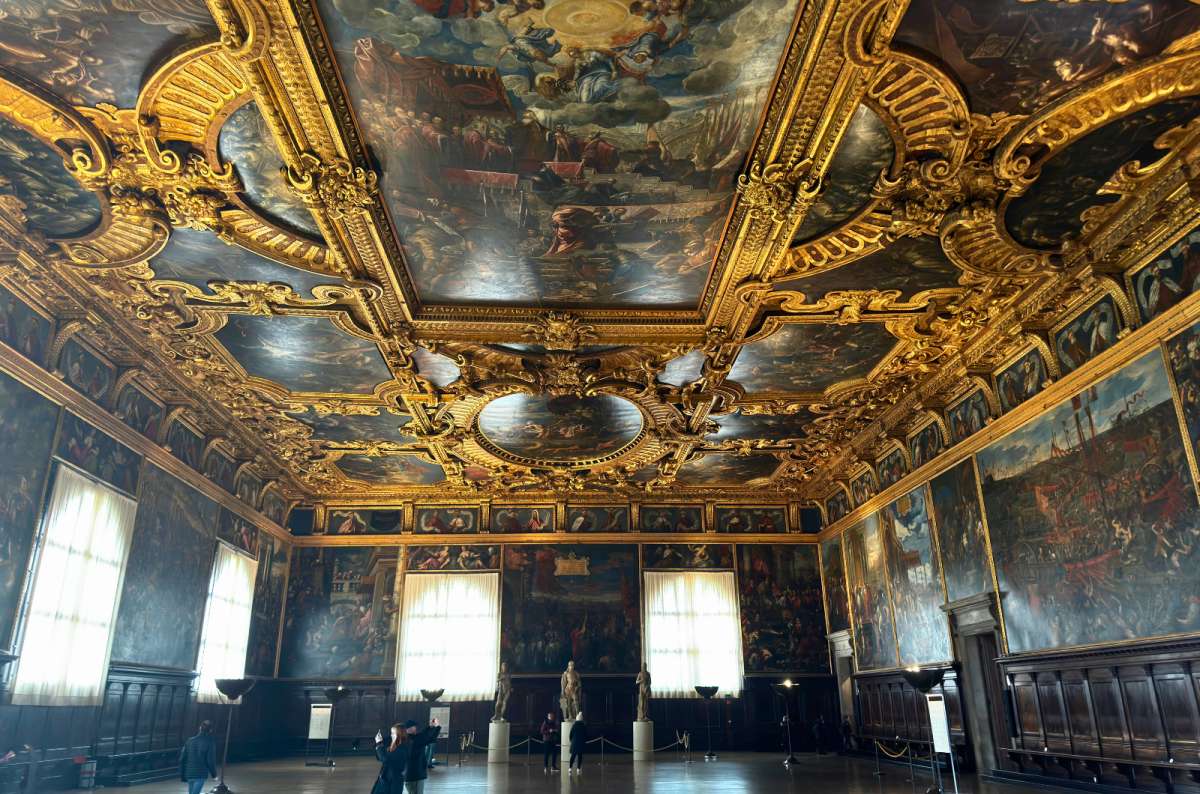 a photo of a grand hall with a gilded painted ceiling inside Doge’s Palace, Venice, Italy, photo by Next Level of Travel