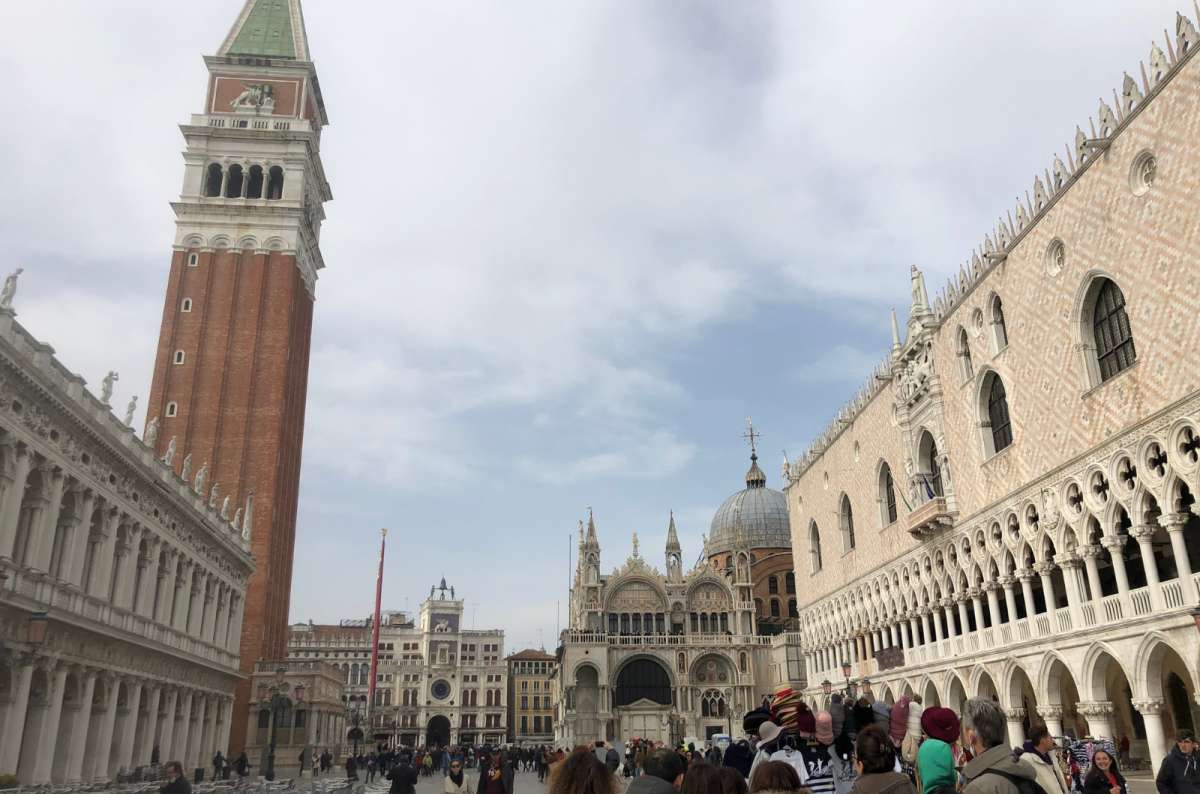 a photo of St. Mark’s Campanile, the Clock Tower, St. Mark’s Basilica and Doge’s Palace seen from the Piazzetta San Marco, Venice, Italy, photo by Next Level of Travel