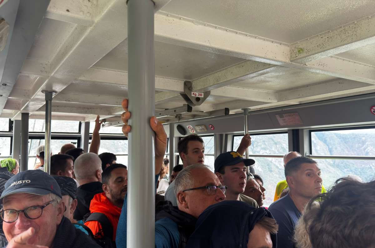 a photo of passengers packed shoulder to shoulder inside the Vogel cable car cabin, Slovenia, photo by Next Level of Travel