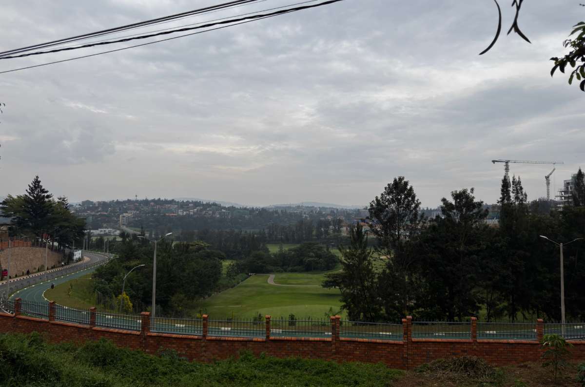 a photo of a green landscape with a road and hills overlooking Kigali, Rwanda, a photo by Next Level of Travel