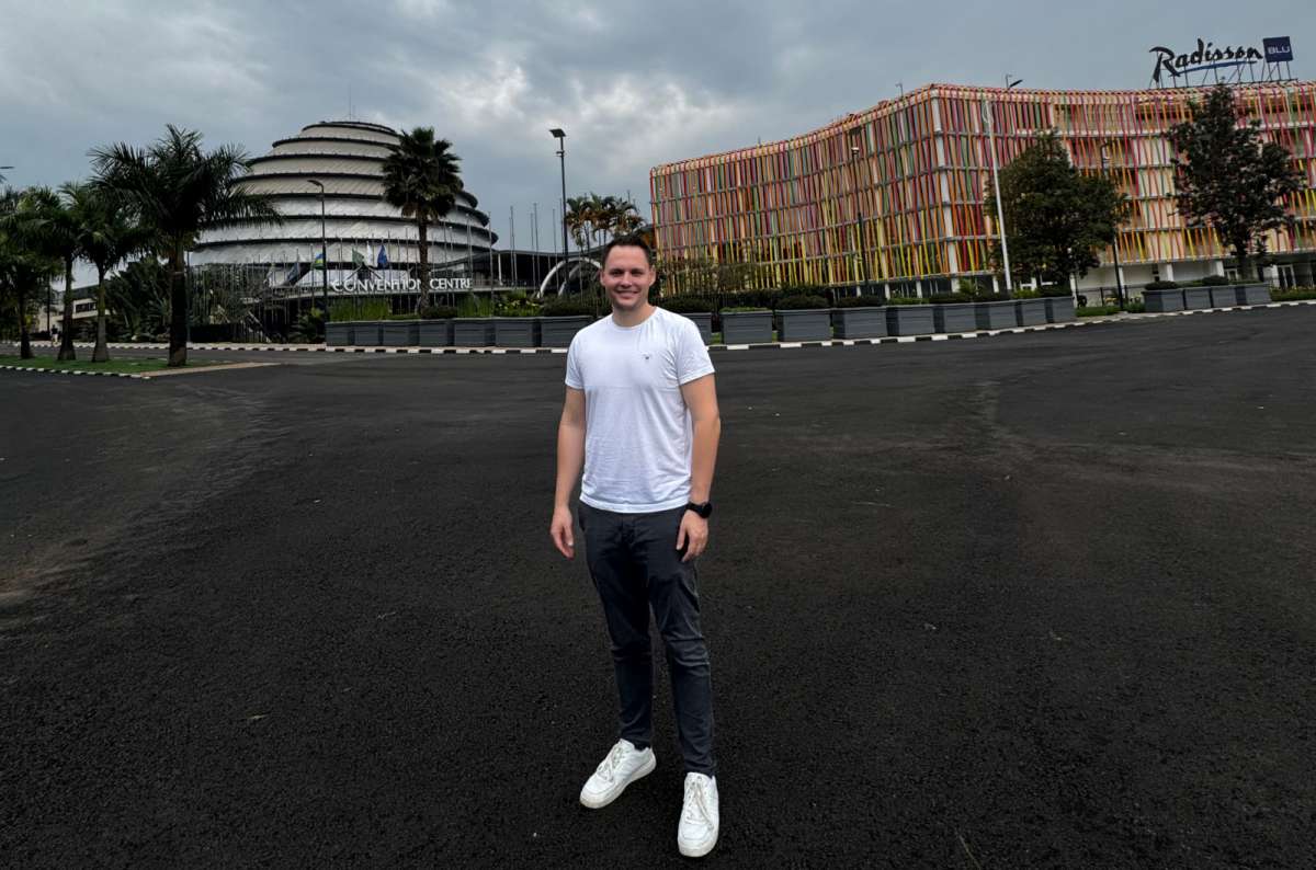 a photo of a tourist standing outside the Kigali Convention Centre and Radisson Blu Hotel in Kigali, Rwanda, a photo by Next Level of Travel