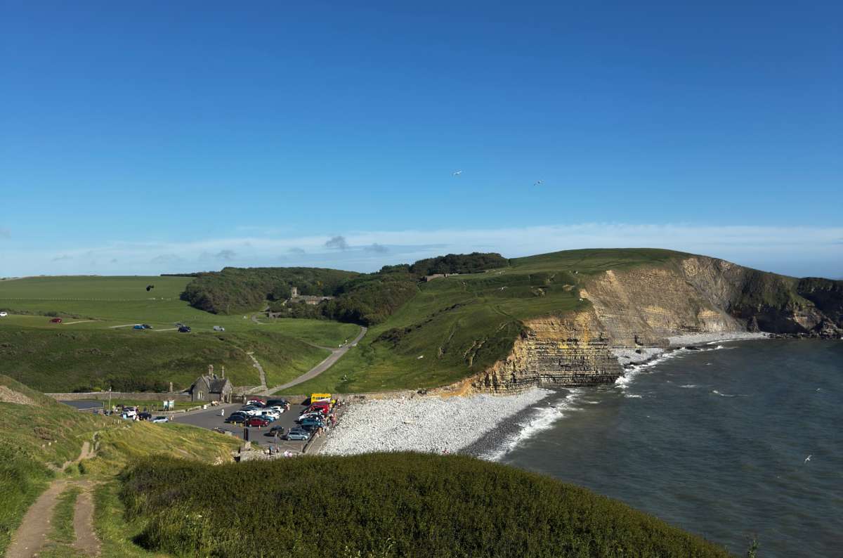 a photo of Dunraven Bay with its pebble beach and car park below the cliffs, Wales, photo by Next Level of Travel