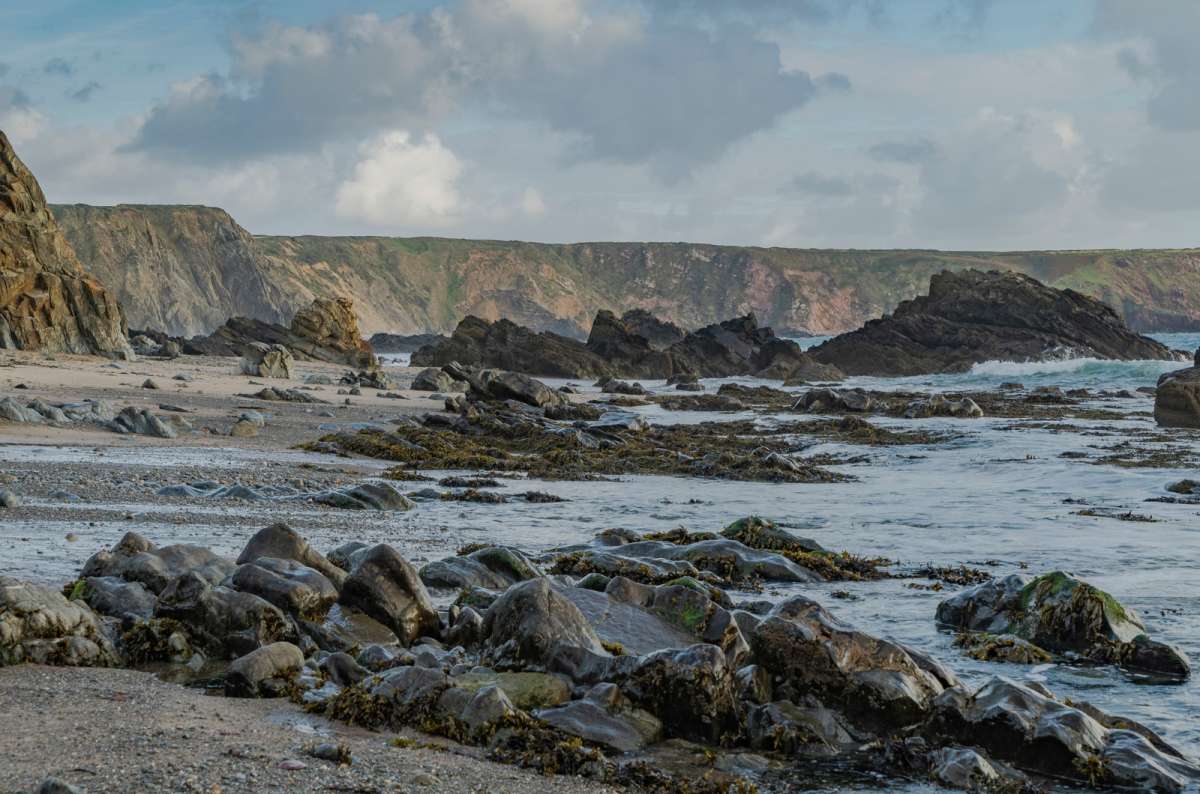 a photo of the jagged rock formations and rock pools of Marloes Sands at low tide, Pembrokeshire, Wales