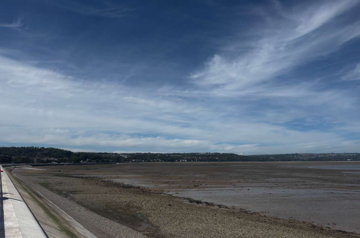 a photo of the wide tidal flats of Swansea Bay at low tide from the promenade, Wales, photo by Next Level of Travel