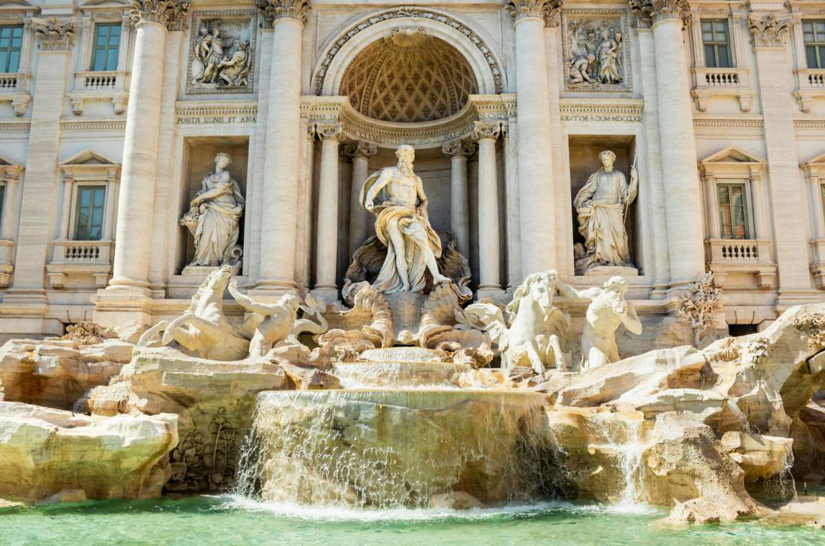 a photo of the Baroque statues and cascading water of the Trevi Fountain, Rome, Italy