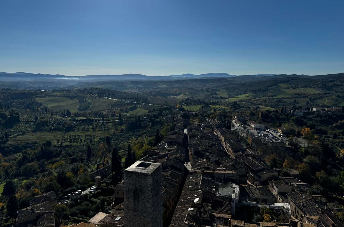 a photo of the rolling Tuscan countryside and vineyards seen from the top of Torre Grossa, San Gimignano, Tuscany, Italy, photo by Next Level of Travel