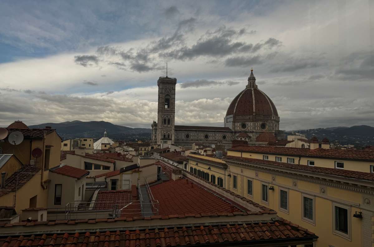 a photo of the terracotta rooftops of Florence with the Duomo and Giotto's Bell Tower on the skyline, Florence, Italy, photo by Next Level of Travel