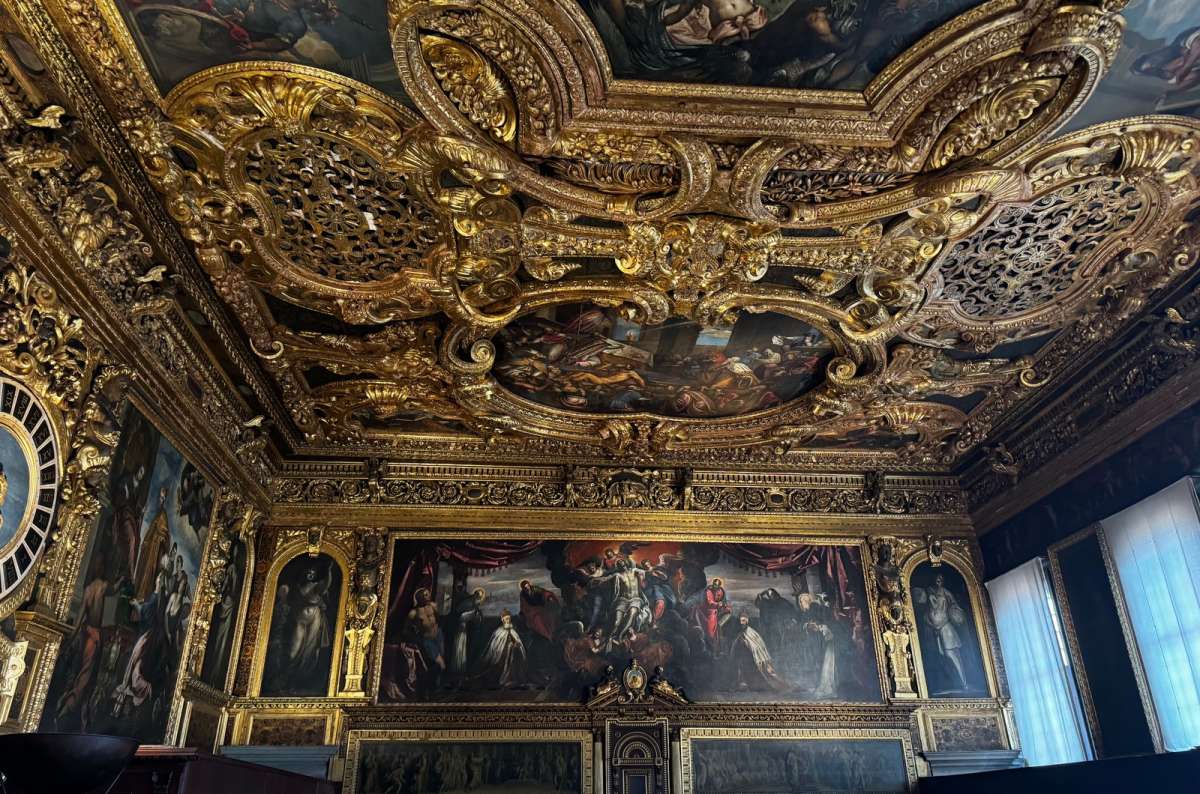 a photo of the gilded ceiling and Tintoretto paintings in the Senate Hall of Doge’s Palace, Venice, Italy, photo by Next Level of Travel