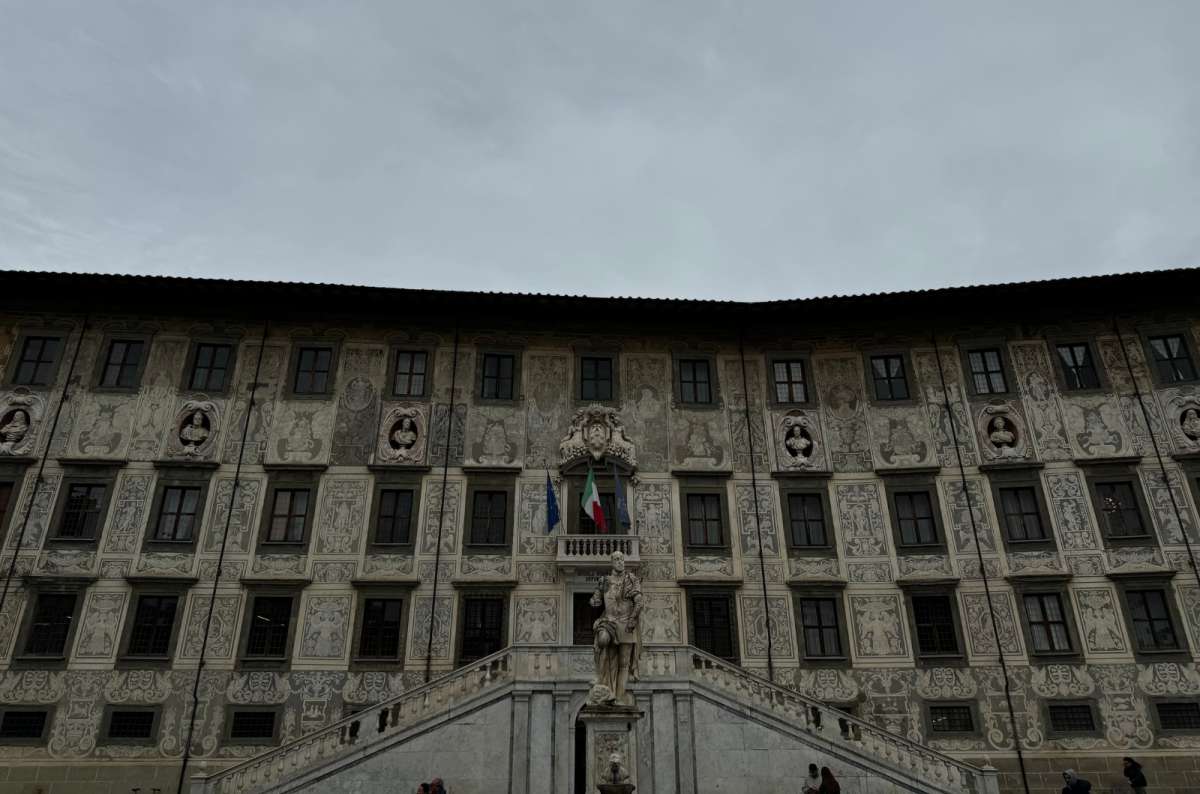 a photo of the decorated sgraffito facade of Palazzo della Carovana on Piazza dei Cavalieri, Pisa, Italy, photo by Next Level of Travel