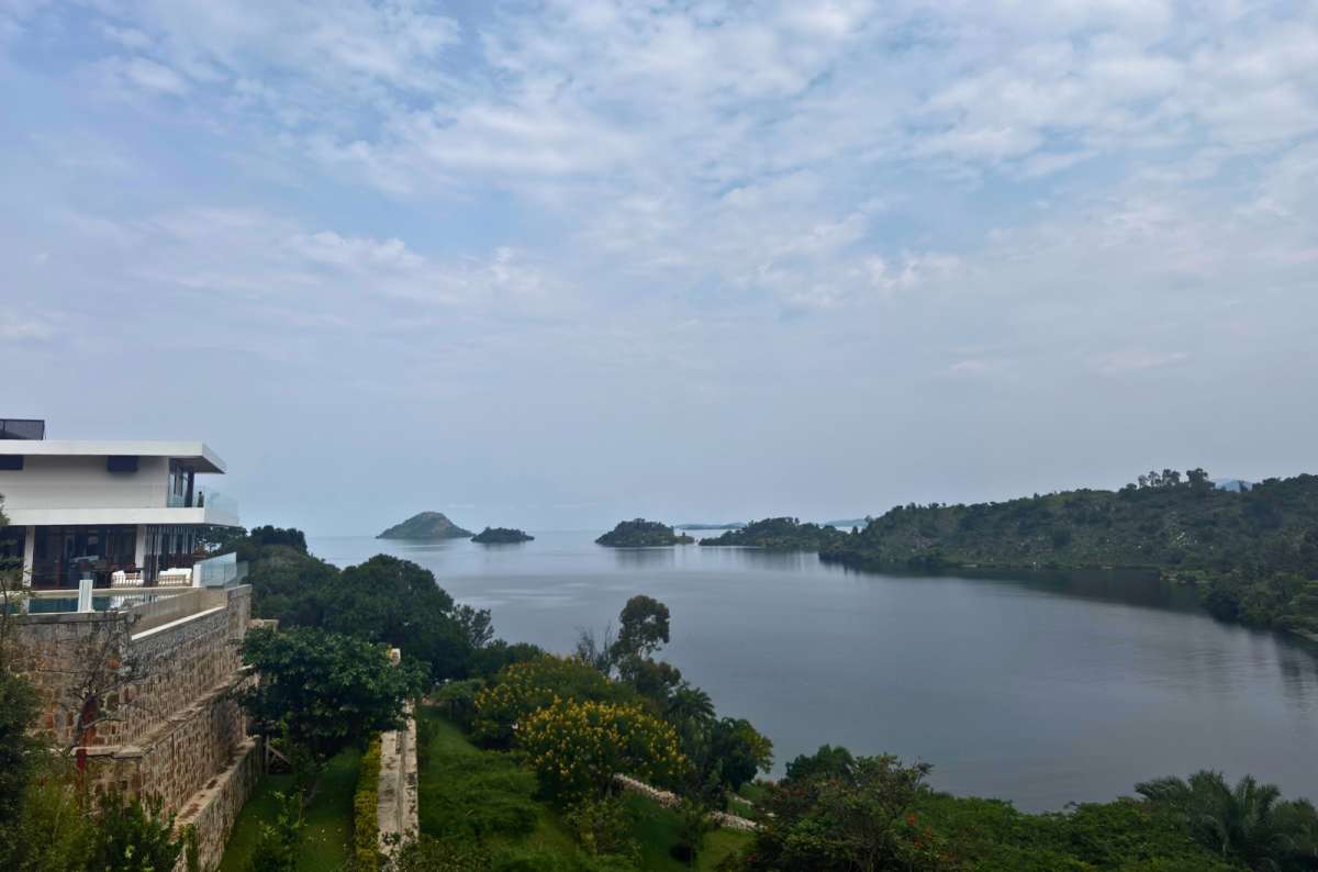 a photo of green islands in Lake Kivu seen from a hillside resort with a pool, near Kibuye, Rwanda, photo by Next Level of Travel