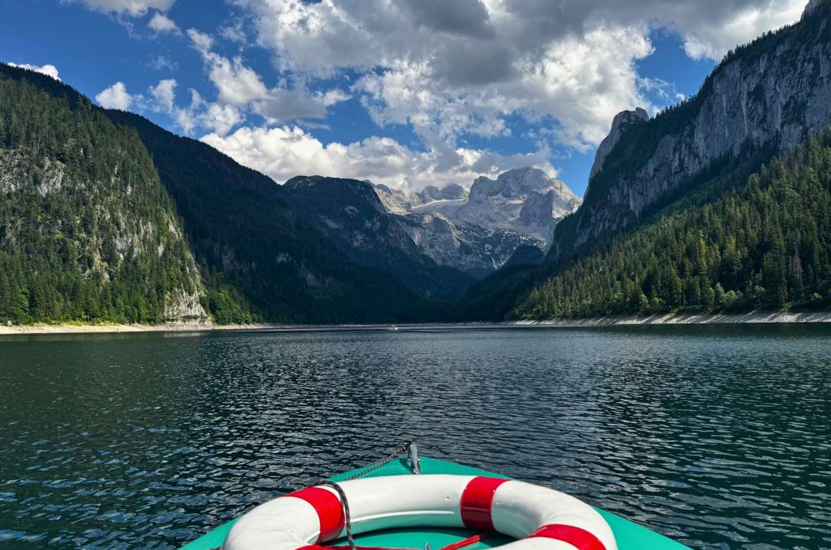 a photo of the Dachstein glacier seen from the bow of a boat on Gosausee, Gosau, Austria, photo by Next Level of Travel
