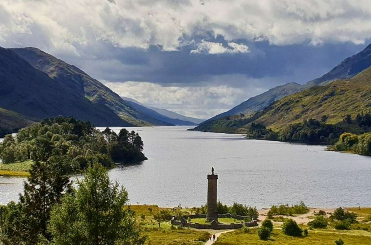 a photo of the Glenfinnan Monument at the head of Loch Shiel seen from the viewpoint above, Scottish Highlands, UK