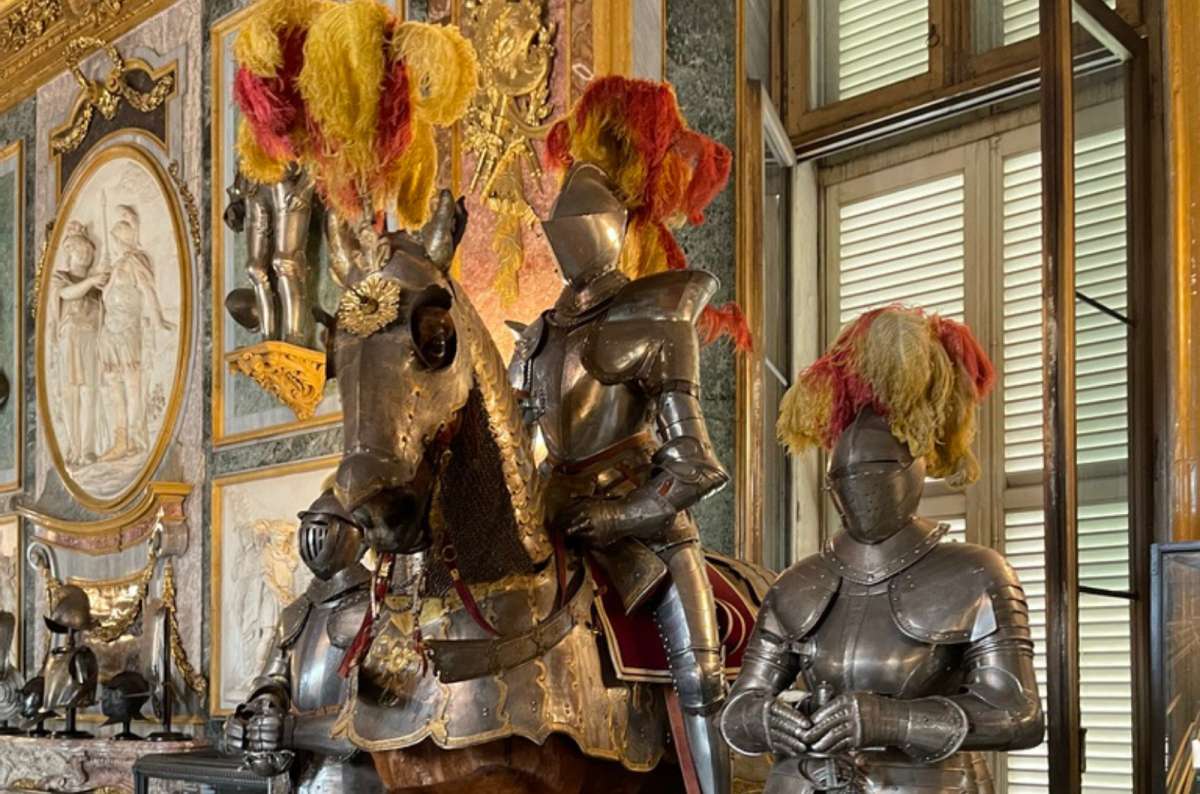 a photo of knights in full armor on horseback in the Royal Armory of the Royal Palace, Turin, Italy, photo by Next Level of Travel