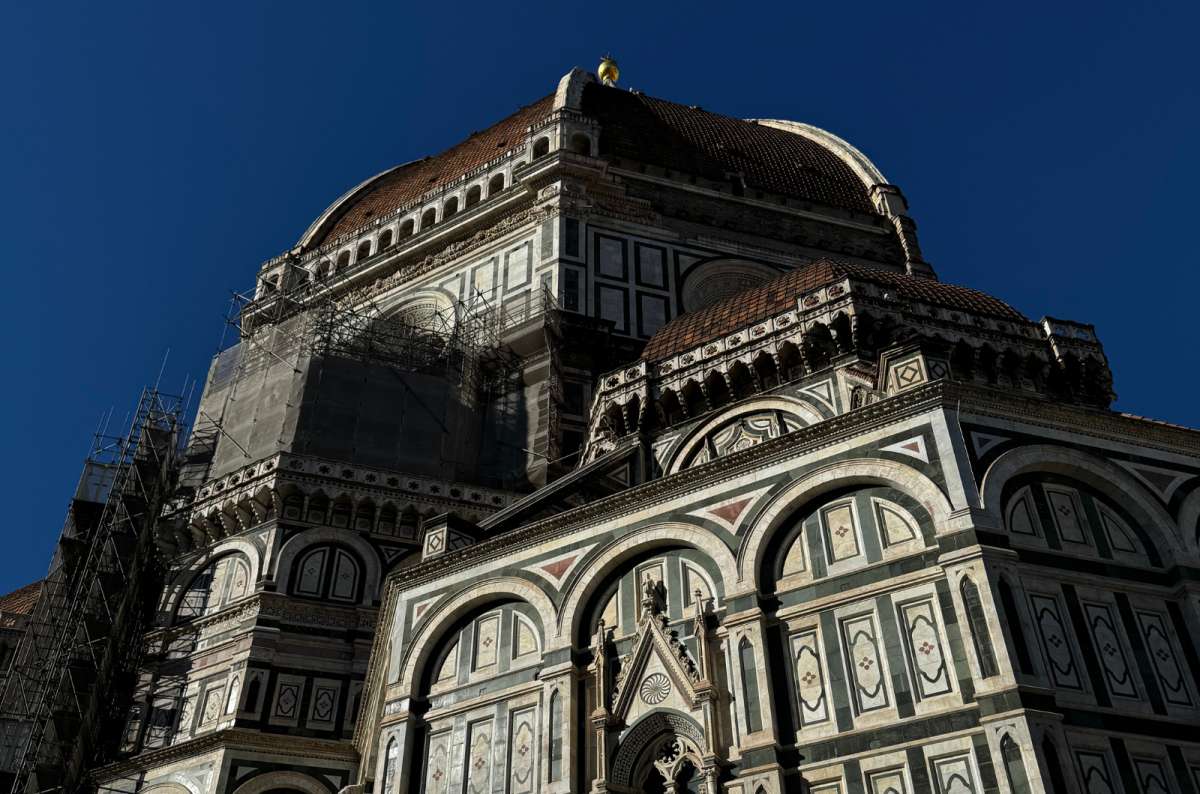 a photo of the green, white and pink marble walls of the Duomo below Brunelleschi's dome, Florence, Italy, photo by Next Level of Travel