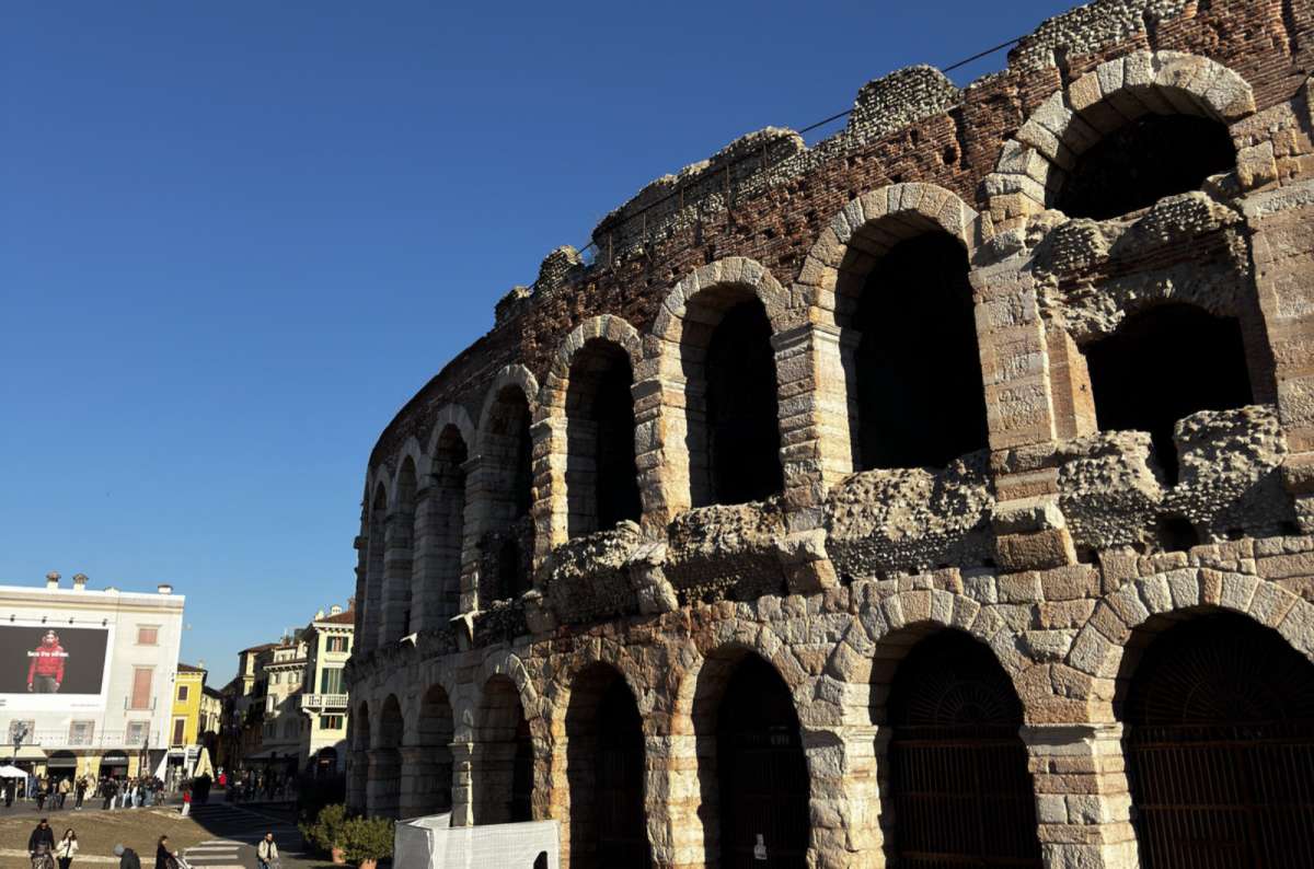 a photo of the outer arches of the Roman Arena under a deep blue sky, Verona, Italy, photo by Next Level of Travel