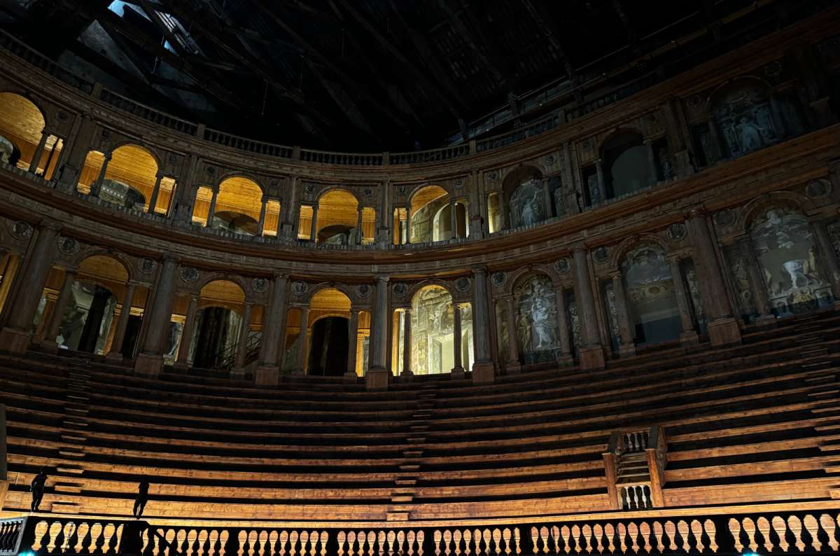a photo of the wooden tiered seating and arches of the Farnese Theater inside Palazzo della Pilotta, Parma, Italy, photo by Next Level of Travel