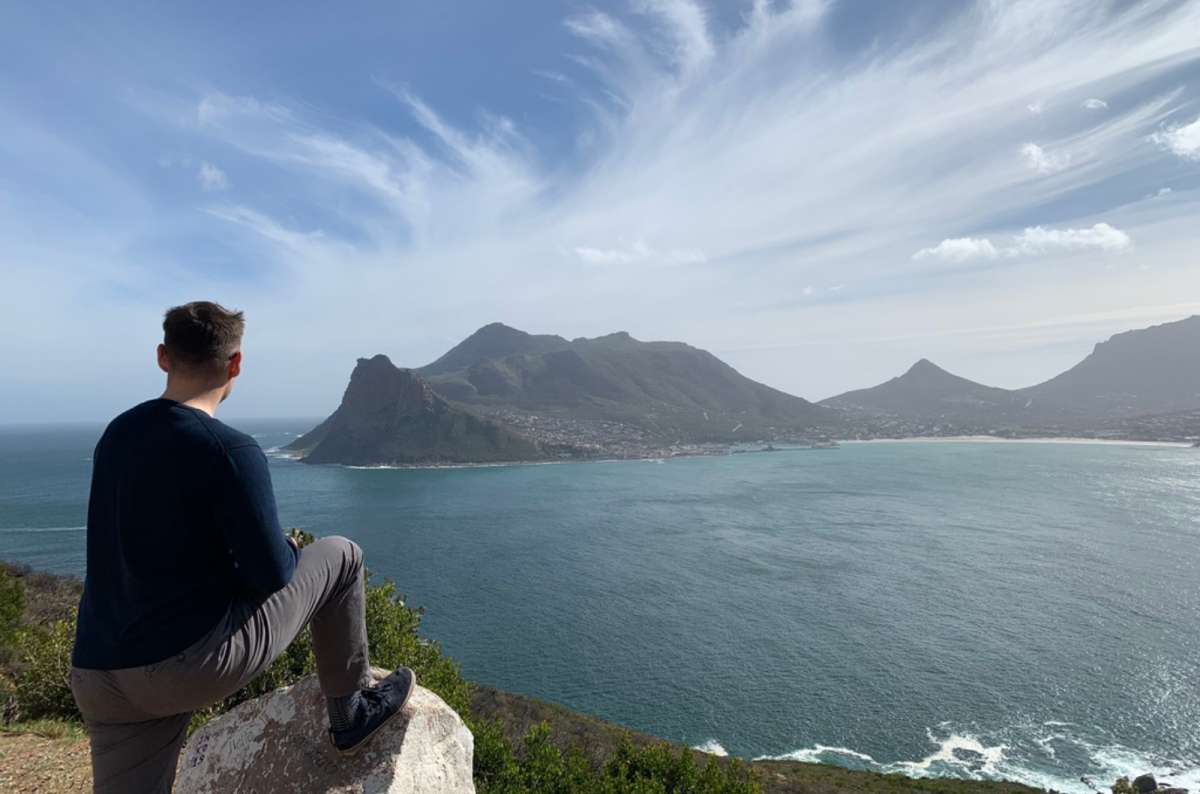 Tourist looking out to the sea from Chapmans Peak, South Africa, photo by Next Level of Travel 