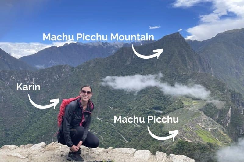 Tourist at Huayna Picchu with a view of Machu Picchu city and mountain 