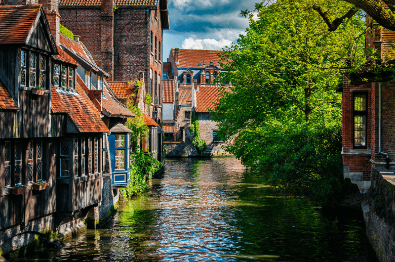 A canal in Bruges with typical buildings lining it